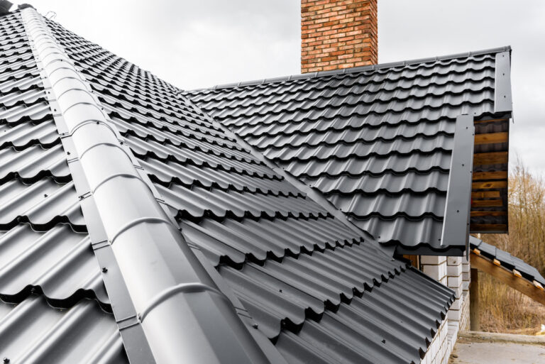 Construction of the roof of the house. Metal tiles.